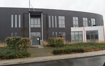 Streetview of dark grey colored office building