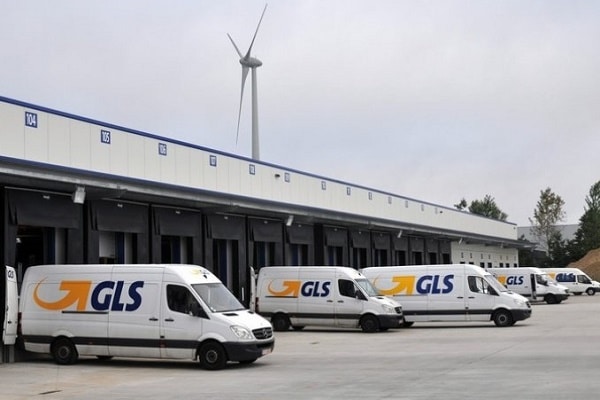 GLS delivery vans getting loaded outside of a warehouse